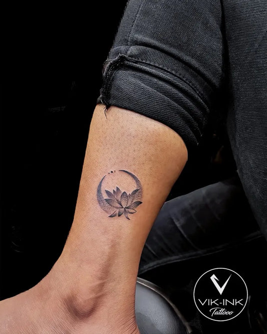 Small Black and Grey Lotus Moon Tattoo on Women Ankle by @vikink_tattooo_nagpur