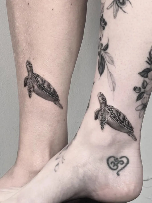 Small Black and Grey Matching Turtle and Flowers Tattoo on Women Leg by @brittnaami