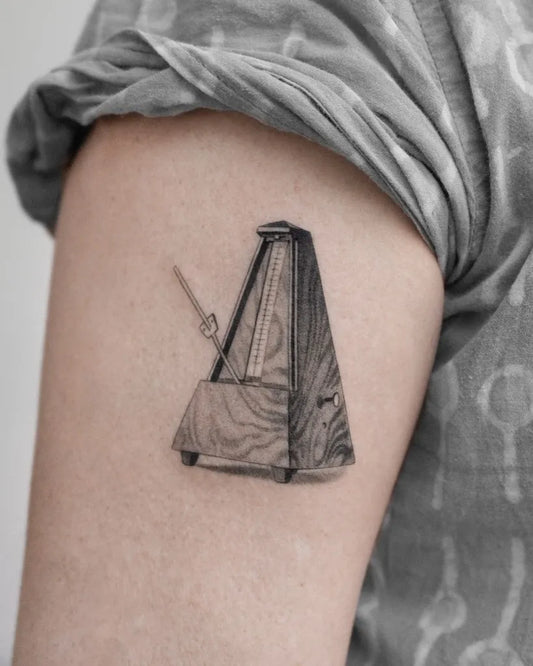 Small Black and Grey Metronome Music Tattoo on Women Arm by @lemontreeink