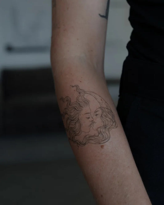 Small Black and Grey Moon Face Tattoo on Women Arm by @akkurat_tattoo_studio