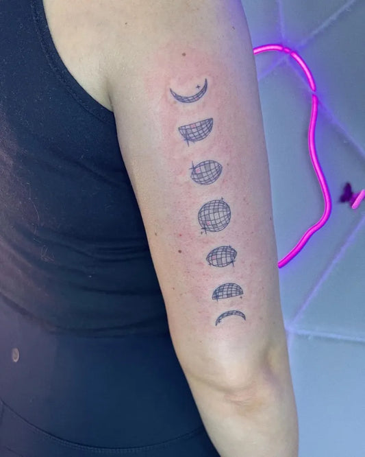 Small Black and Grey Moon Phases Tattoo on Women Arm by @cultofspice