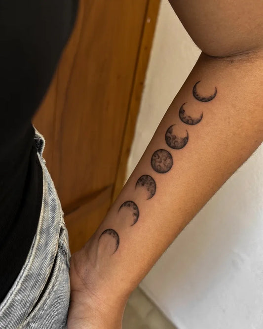 Small Black and Grey Moon Phases Tattoo on Women Forearm by @cahhks