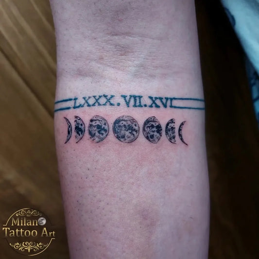 Small Black and Grey Moon Phases and Roman Numerals Tattoo on Women Wrist by @milano_tattooart