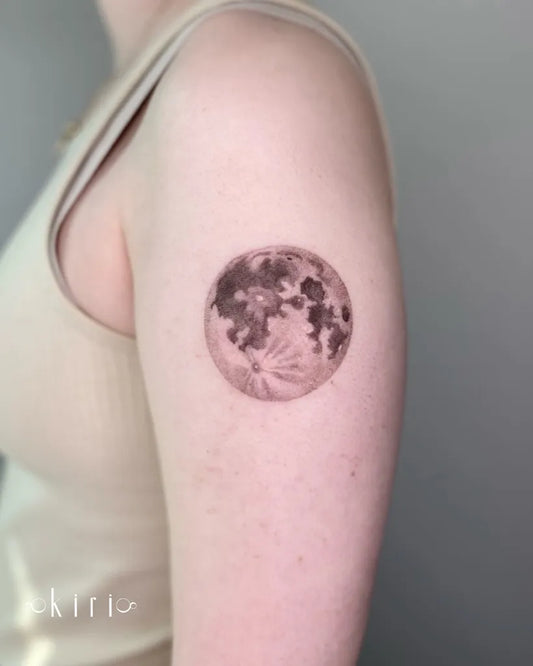 Small Black and Grey Moon Tattoo on Women Upper Arm by @kiri.vrs
