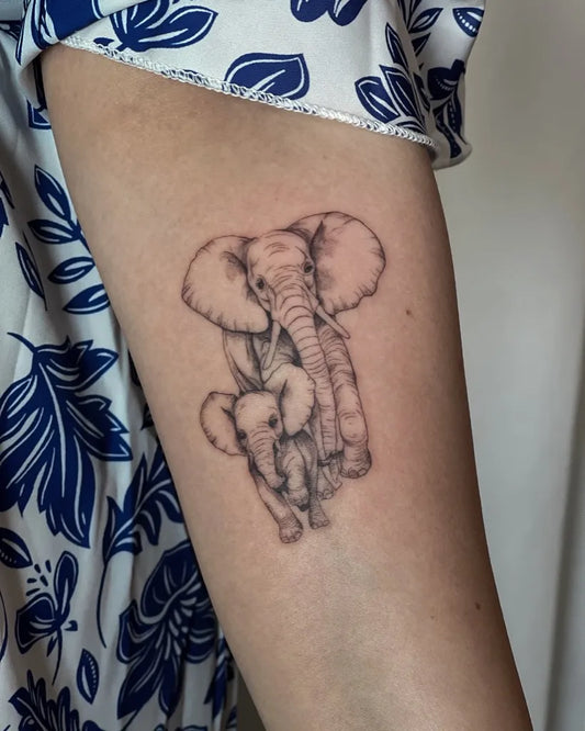 Small Black and Grey Mother and Son Elephant Tattoo on Women Arm by @fein.lines