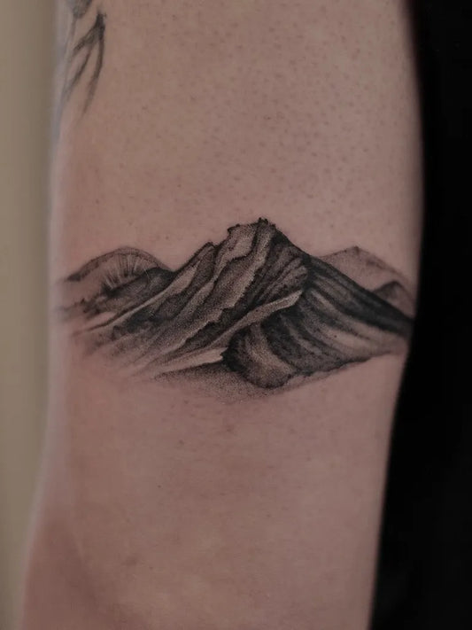 Small Black and Grey Mountain Tattoo on Men Arm by @hayden_vegantattooartist