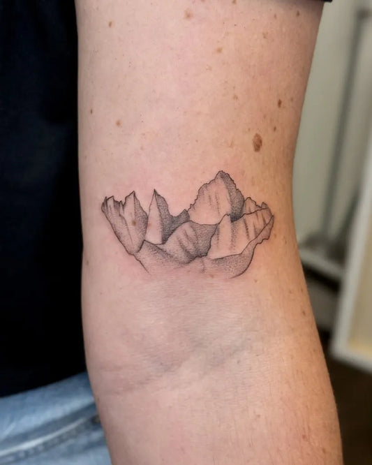 Small Black and Grey Mountain Tattoo on Women Arm by @hitzink