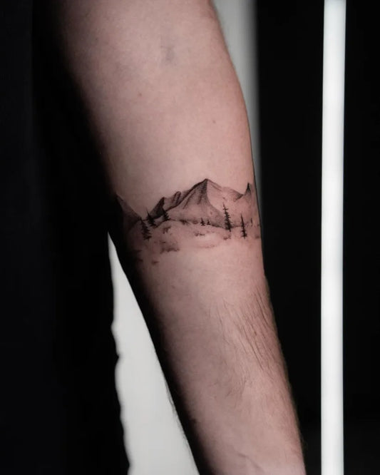 Small Black and Grey Mountain and Trees Tattoo on Men Arm by @hannyttt