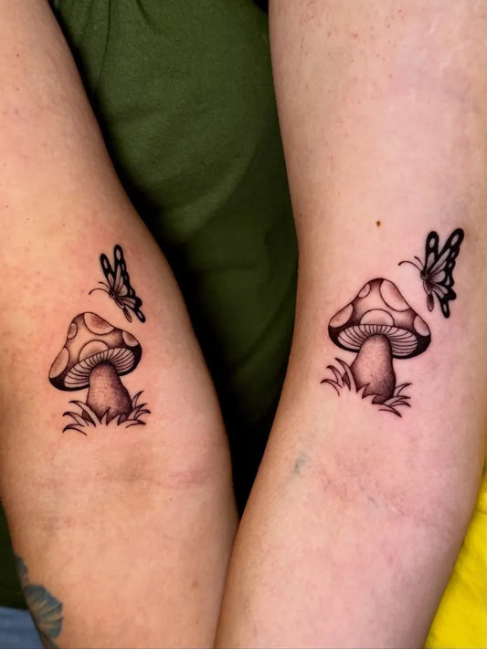 Small Black and Grey Mushroom and Butterfly on Women Arm Tattoo by @divineenergytattoostudio