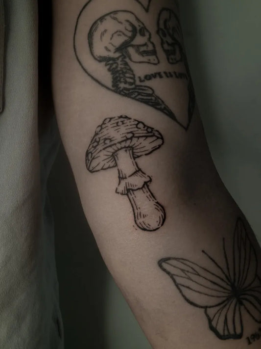 Small Black and Grey Mushroom and Skeleton Heart on Women Arm Tattoo by @mama_orca_