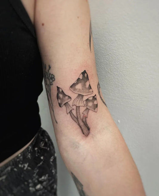Small Black and Grey Mushrooms on Women Arm Tattoo by @clairedaisytattoos