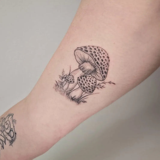 Small Black and Grey Mushrooms on Women Arm Tattoo by @wildflowers.tattoo