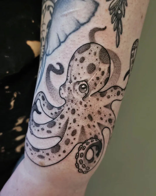 Small Black and Grey Octopus Tattoo on Women Arm by @csankeytat2s