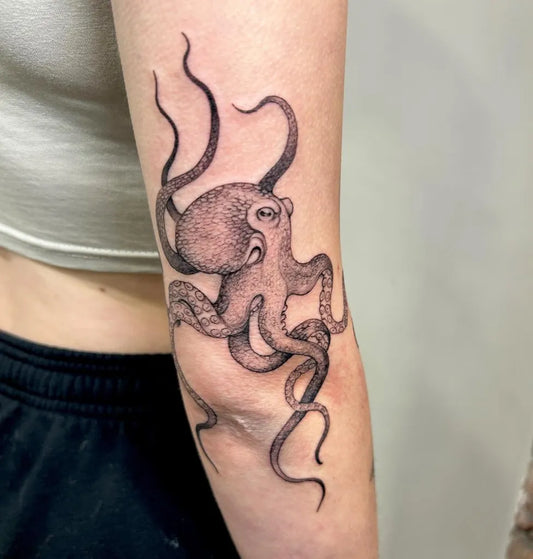 Small Black and Grey Octopus Tattoo on Women Arm by @larastarktattoo