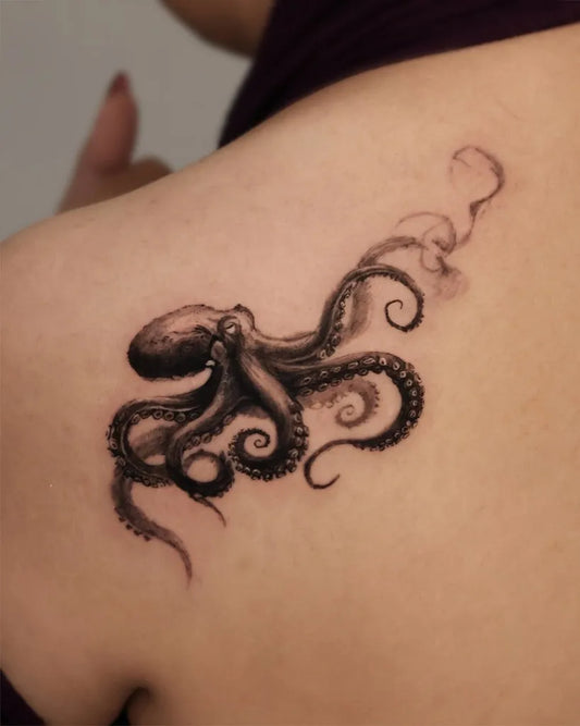 Small Black and Grey Octopus Tattoo on Women Shoulder by @jisoo_tattoo
