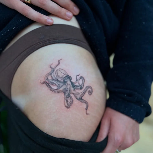 Small Black and Grey Octopus Tattoo on Women Thigh by @kaden_tatatau