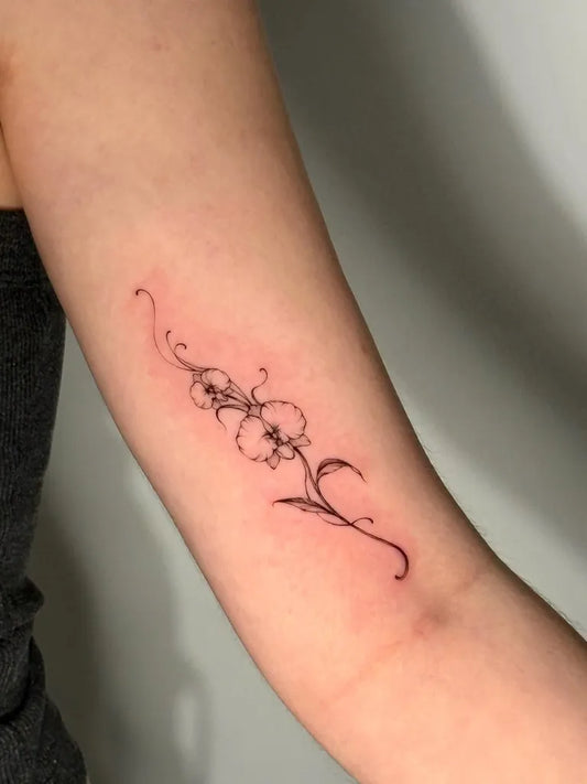 Small Black and Grey Orchid Flowers Tattoo on Women Arm by @wooyootattoo