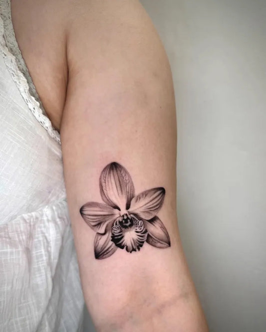 Small Black and Grey Orchid Tattoo on Women Arm by @smartartstattoo