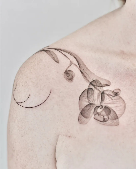 Small Black and Grey Orchid and Vines Tattoo on Women Shoulder by @eloula.tattoo
