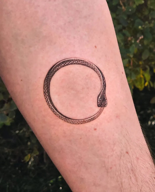 Small Black and Grey Ouroboros Tattoo on Men Arm by @graiey