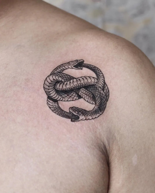 Small Black and Grey Ouroboros Tattoo on Men Shoulder by @darrenwentattoo