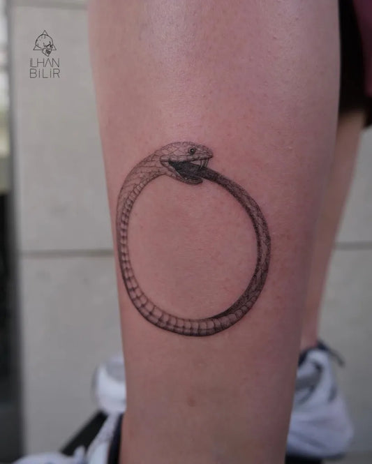 Small Black and Grey Ouroboros Tattoo on Women Leg by @ilhan_bilir
