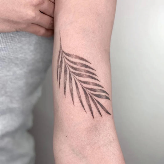 Small Black and Grey Palm Leaf Tattoo on Women Arm by @graycodetattoo