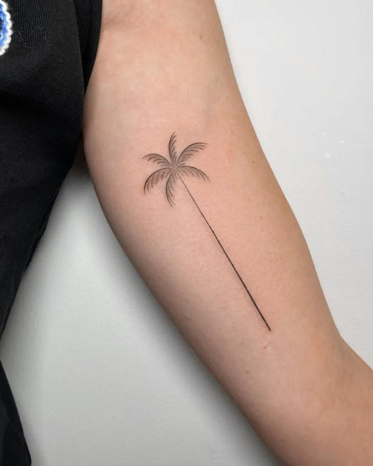 Small Black and Grey Palm Tree Tattoo on Women Arm by @dylanlongcho