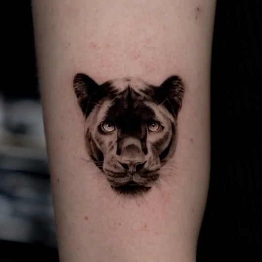 Small Black and Grey Panther Head Tattoo on Women Arm by @turner_tattoos