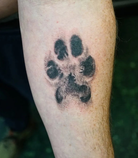 Small Black and Grey Paw Print Tattoo on Men Arm by @ithacapiercingandtattoo