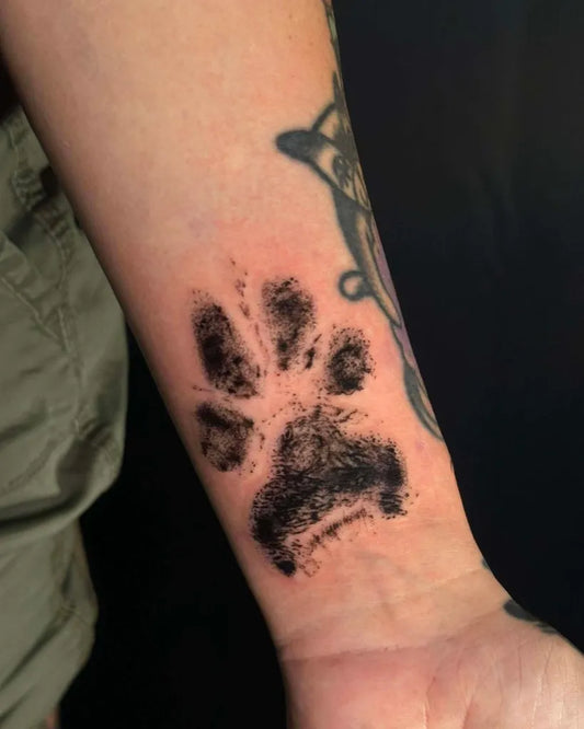 Small Black and Grey Paw Print Tattoo on Women Wrist by @eastsideringwood