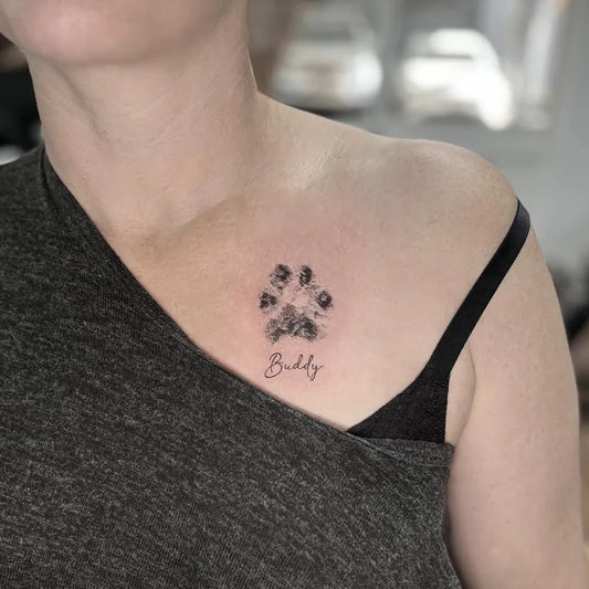 Small Black and Grey Paw Print and Name Tattoo on Women Chest by @allinktattoo.com.au