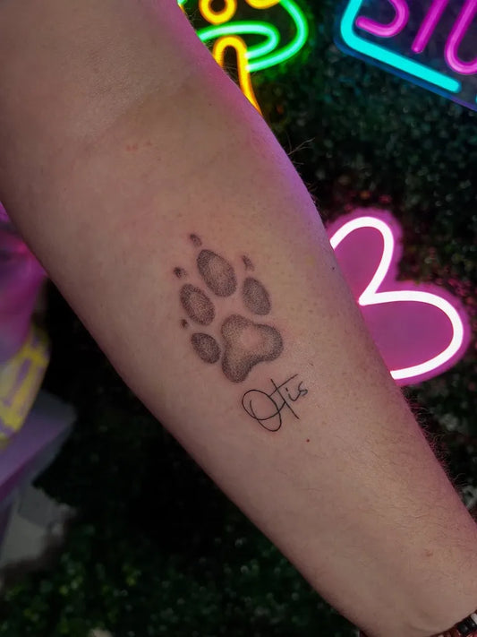 Small Black and Grey Paw Print and Name Tattoo on Women Forearm by @haphearttattoo