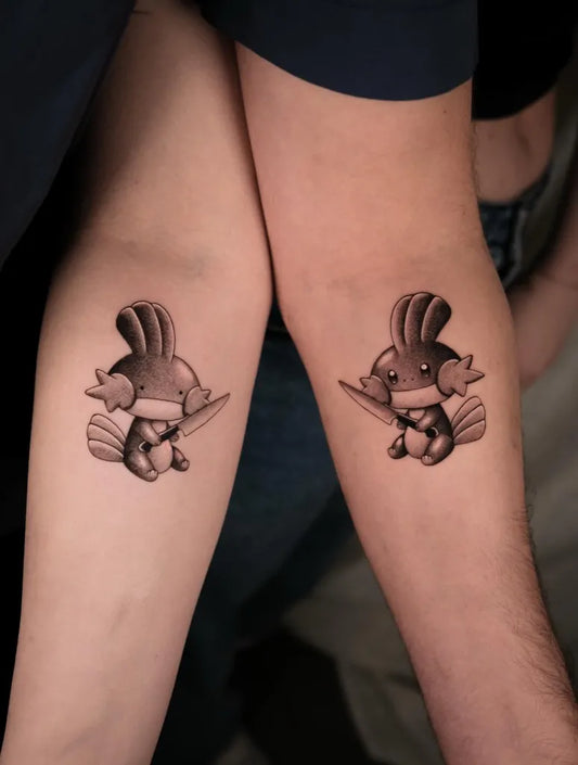 Small Black and Grey Pokemon Tattoo on Women Arm by @eclipse.ttt_