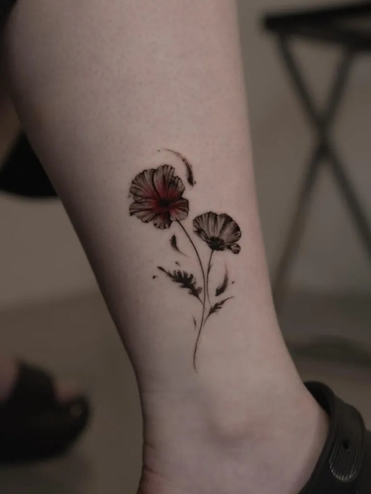 Small Black and Grey Poppy Flowers Tattoo on Women Ankle by @joyk_lights