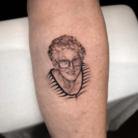 Small Black and Grey Portrait of Older Woman Family Tattoo on Women Leg by @fuhrichtattoo