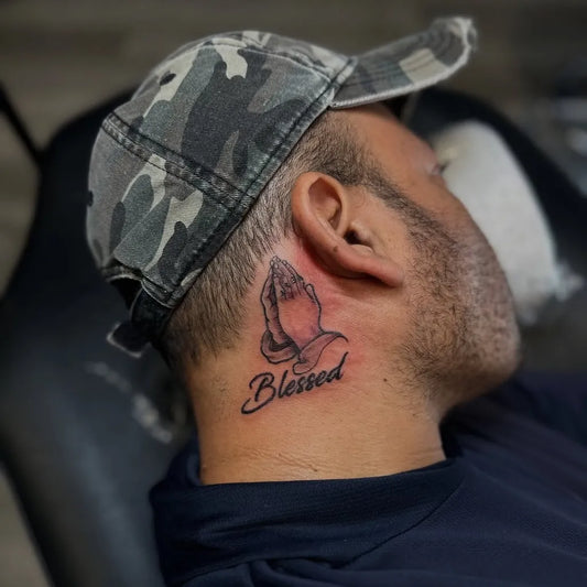 Small Black and Grey Praying Hands with Blessed Tattoo on Men Neck by @tattoosbybj