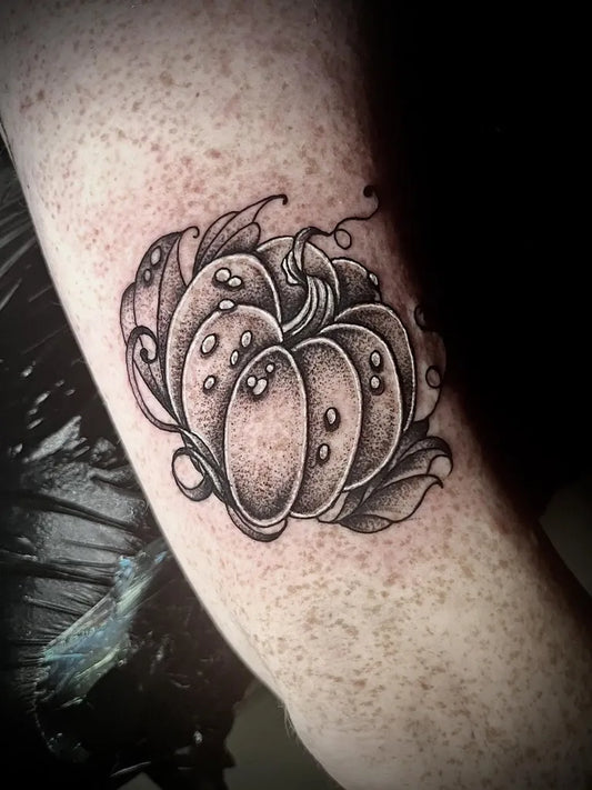 Small Black and Grey Pumpkin Halloween Tattoo on Women Arm by @chainsawdarling