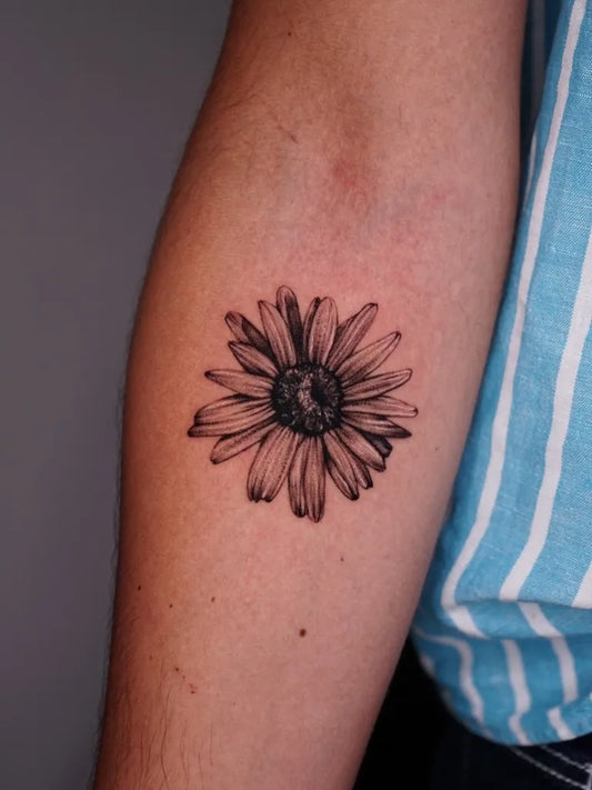 Small Black and Grey Realism Daisy Tattoo on Women Arm by @la.tatuattrice
