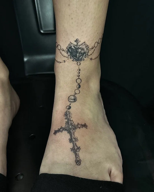 Small Black and Grey Rosary and Cross Tattoo on Women Ankle by @cloudy.iink
