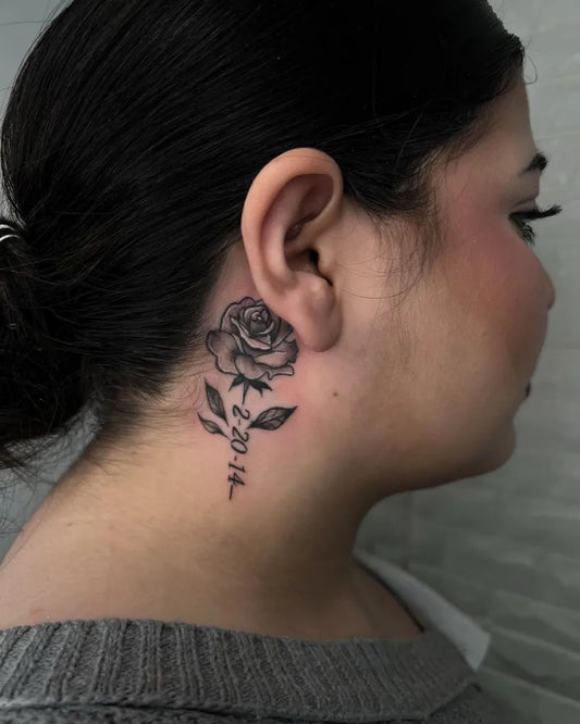 Small Black and Grey Rose with Letters Tattoo on Women Behind the Ear by @_jenjenbaby