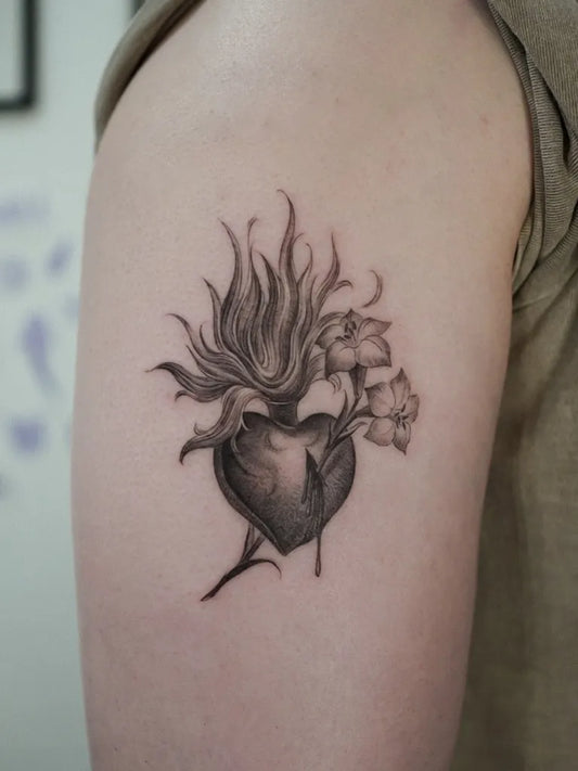 Small Black and Grey Sacred Heart with Flowers and Flames Tattoo on Women Arm by @komi.tt
