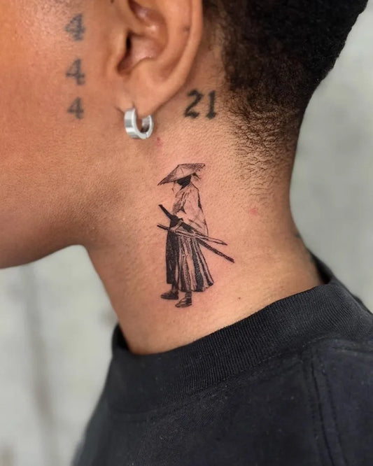 Small Black and Grey Samurai with Sword Tattoo Behind the Ear by @tmkoo.tattoo