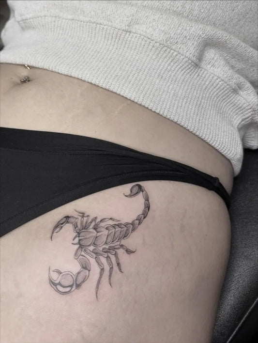 Small Black and Grey Scorpion on Women Hip Tattoo by @star.girl.tats