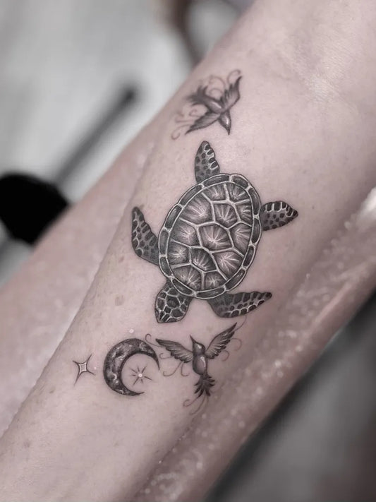 Small Black and Grey Sea Turtle Birds Moon Tattoo on Women Arm by @amandacreek