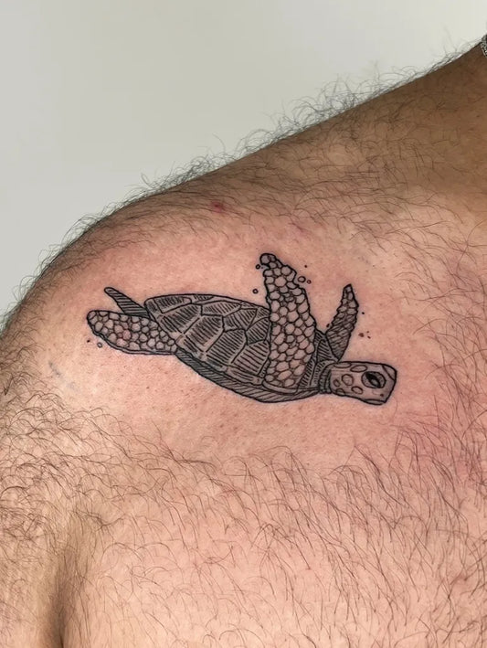 Small Black and Grey Sea Turtle Tattoo on Men Shoulder by @tezerd_