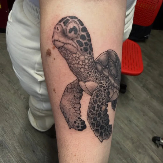 Small Black and Grey Sea Turtle Tattoo on Women Arm by @alinothetentacle