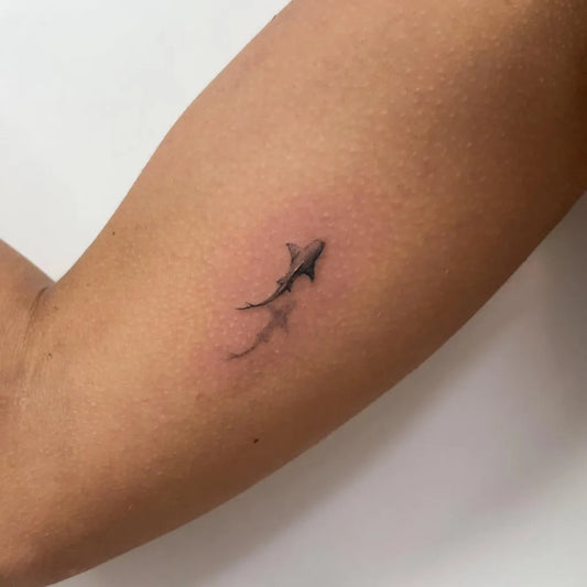 Small Black and Grey Shark on Women Arm Tattoo by @lacosanostratattooshoptenerife