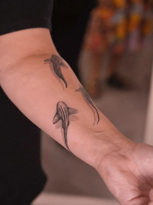 Small Black and Grey Sharks on Women Arm Tattoo by @nikastattooartistry