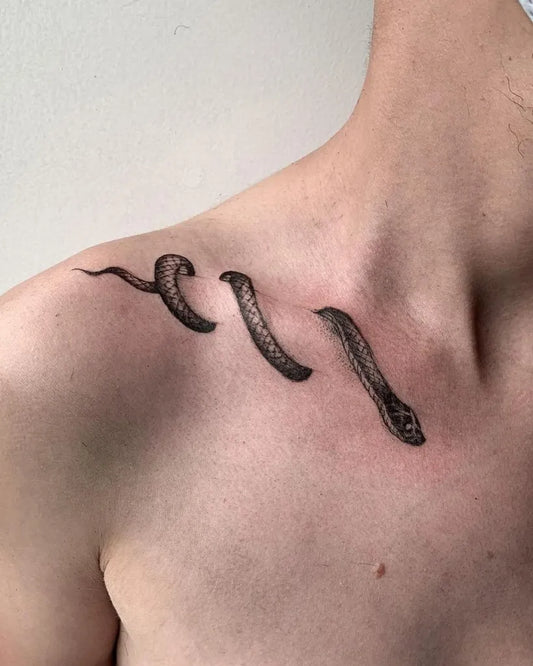 Small Black and Grey Snake Tattoo on Men Collarbone by @blxckink